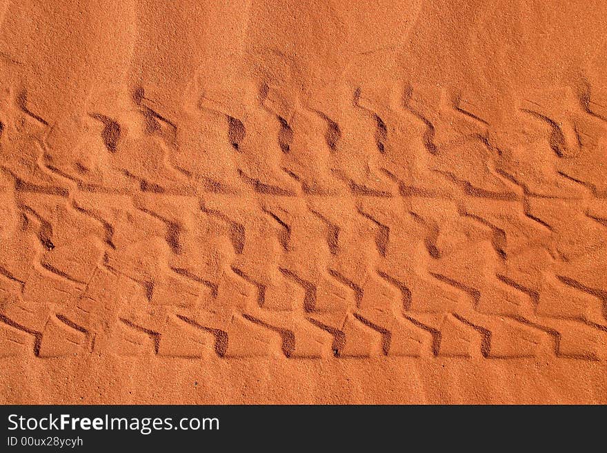 Close shot of a red rural road with car tracks in sand. Rainbow valley, Southern Northern Territory.  Australia