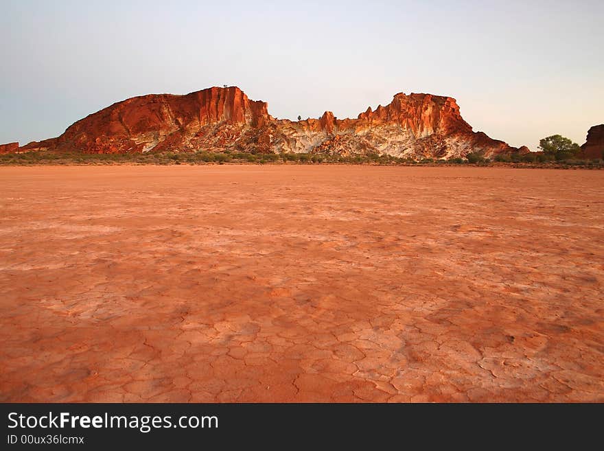 Parched red grounds with famous rocky range. Rainbow valley, Southern Northern Territory, Australia. Parched red grounds with famous rocky range. Rainbow valley, Southern Northern Territory, Australia