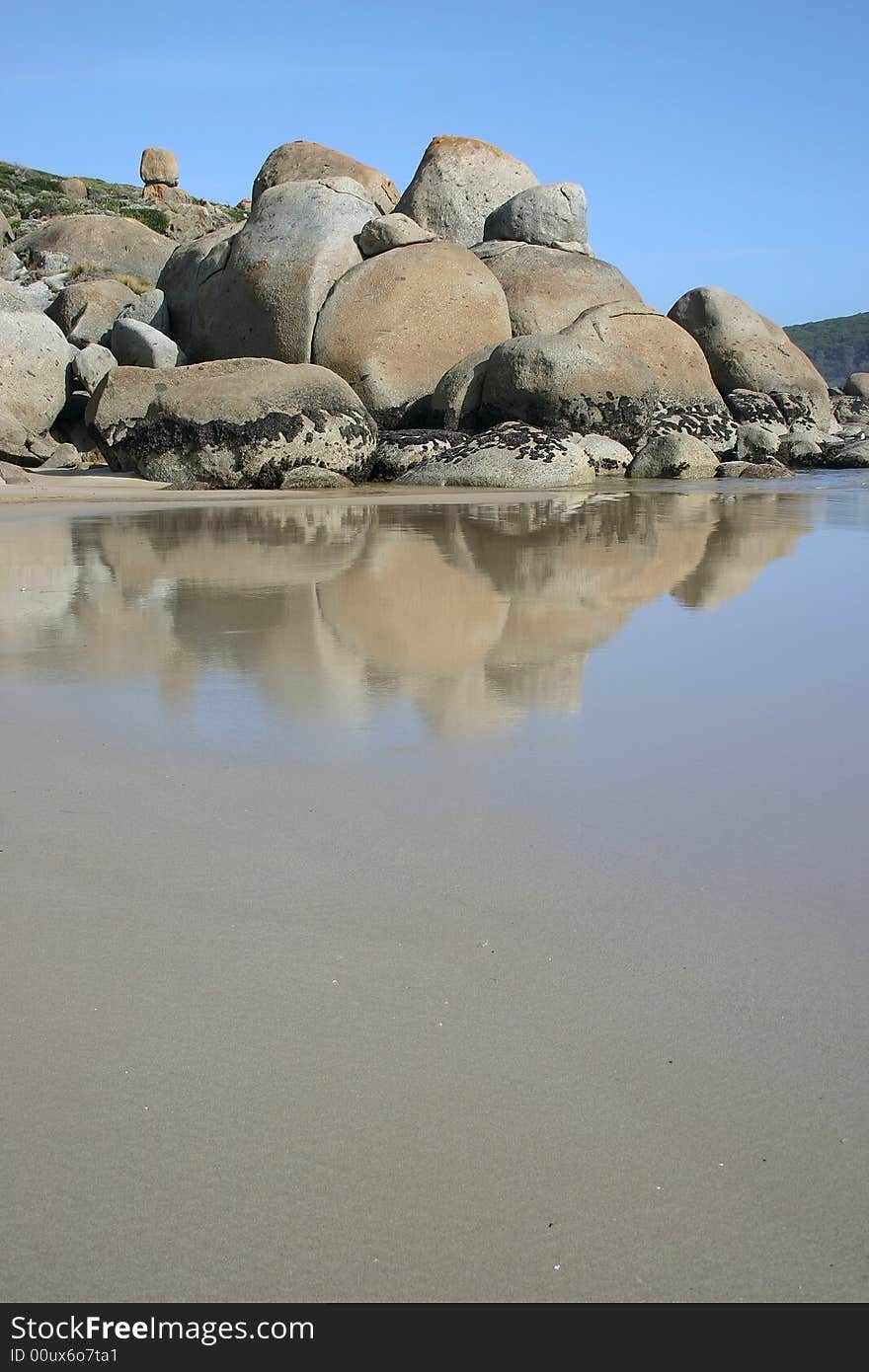 Wet sand with famous stones of Wilsons Promontory national park. Victoria. Australia