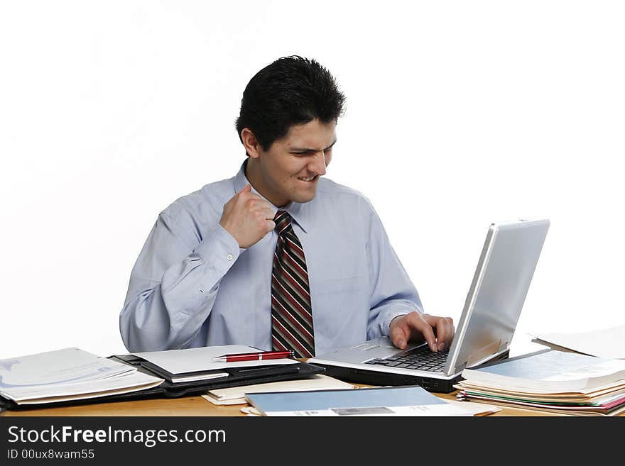 Business man pumping his fist while working at his laptop. Business man pumping his fist while working at his laptop