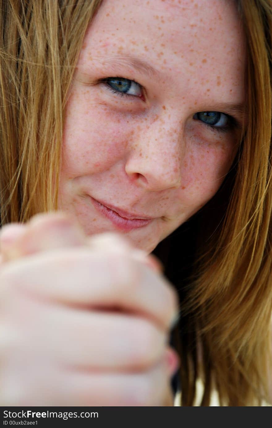 A teenager with a cheeky grin arm wrestling. A teenager with a cheeky grin arm wrestling