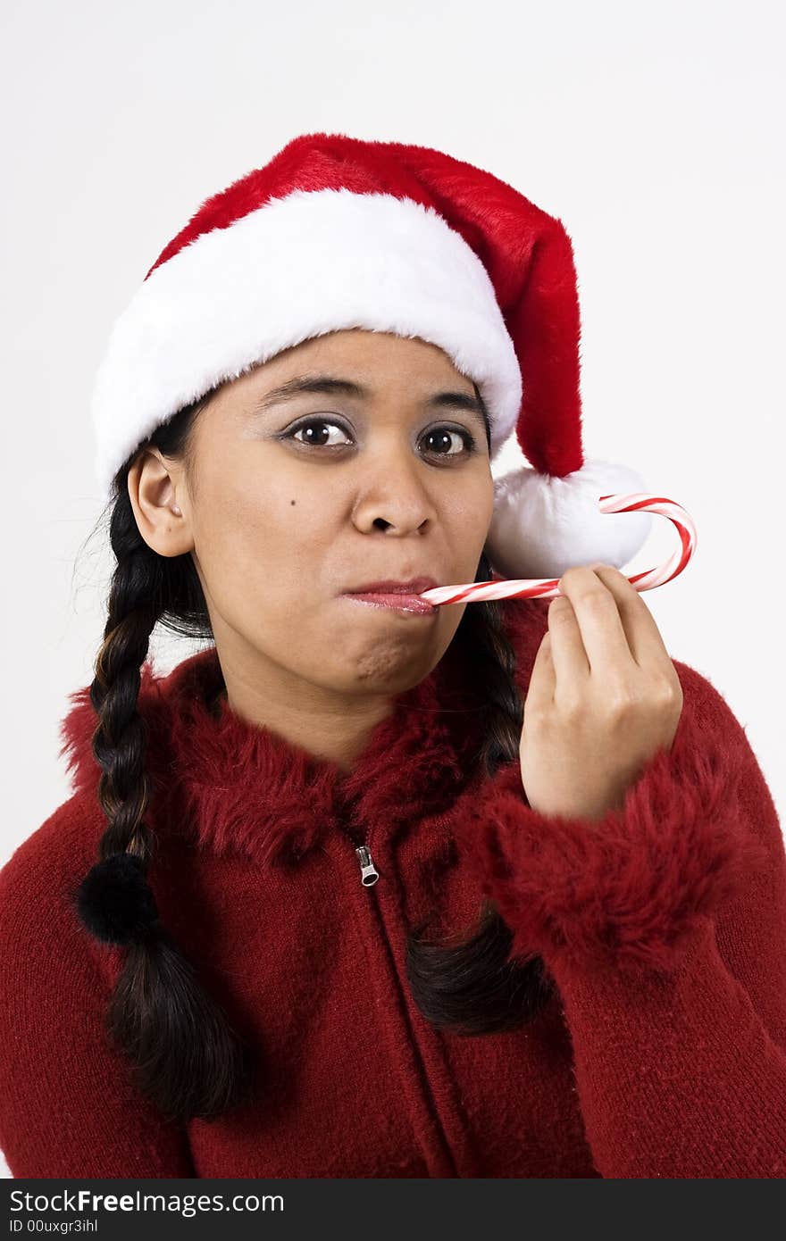 Vertical image of girl in a santa hat and candy cane. Vertical image of girl in a santa hat and candy cane