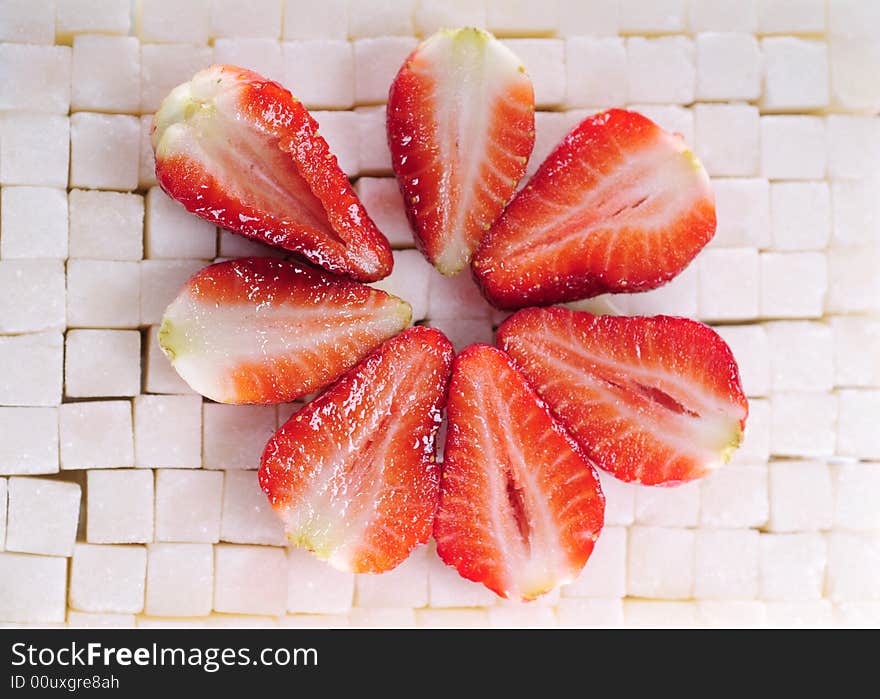 White sugar cubes background with strawberry. White sugar cubes background with strawberry