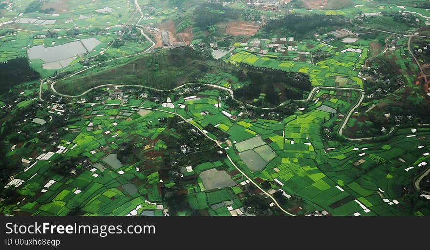 Beautiful green field with river and road