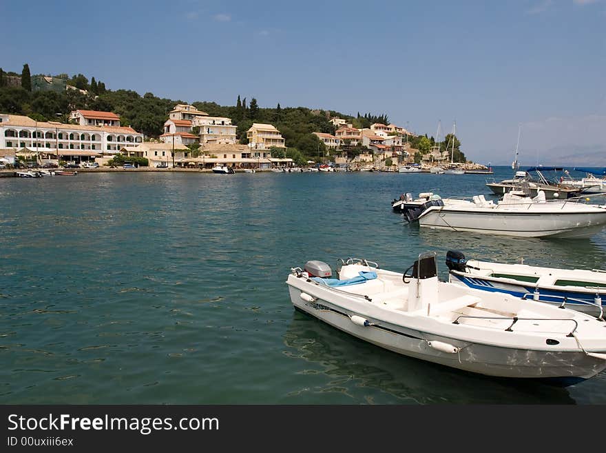 Boats and typical greek house near sea at Kassiopi. Boats and typical greek house near sea at Kassiopi