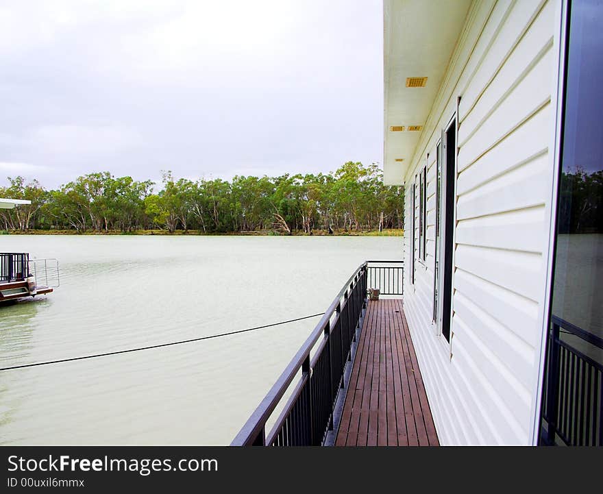 Photograph featuring a houseboat at Border Cliffs on the River Murray under a rare stormy sky (South Australia). Photograph featuring a houseboat at Border Cliffs on the River Murray under a rare stormy sky (South Australia).