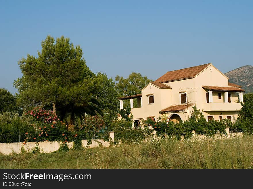 Typical greek architecture house with green garden. Typical greek architecture house with green garden