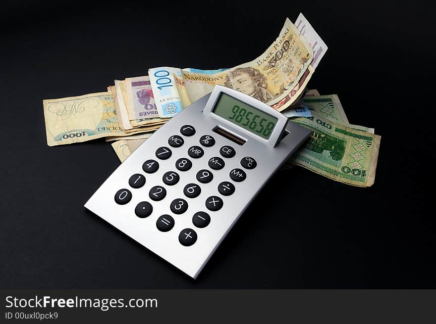 Money and calculator on a black background