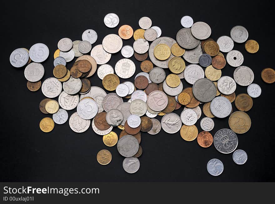 Assorted coins on a black background