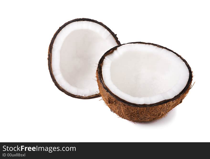 Two halves of a coconut on white background (focus on front piece). Two halves of a coconut on white background (focus on front piece)