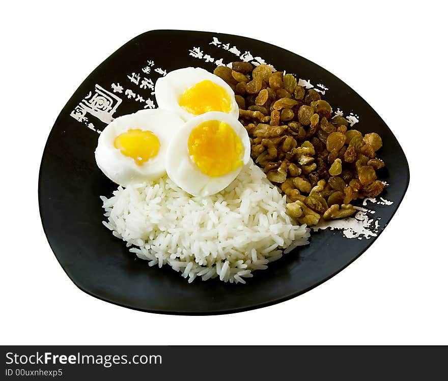 Rice, eggs, nuts and raisin on the isolated plate with hieroglyphes. Rice, eggs, nuts and raisin on the isolated plate with hieroglyphes