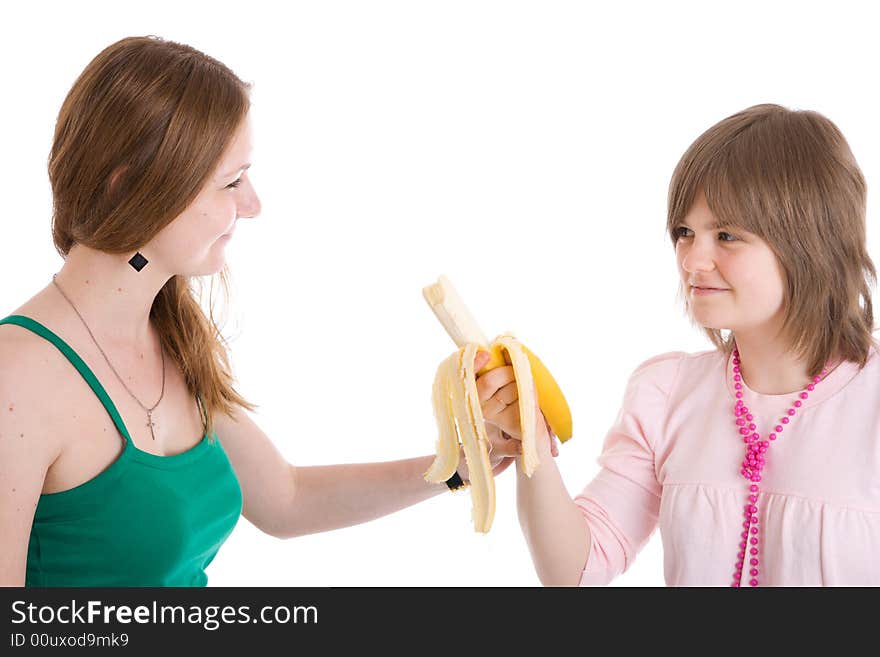 The two young attractive girl with a banana isolated on a white background. The two young attractive girl with a banana isolated on a white background