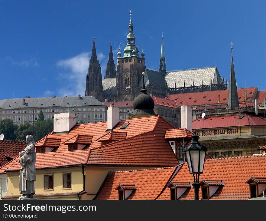 Cathedral of saint Vitus in Prague with tiled roofs in front of