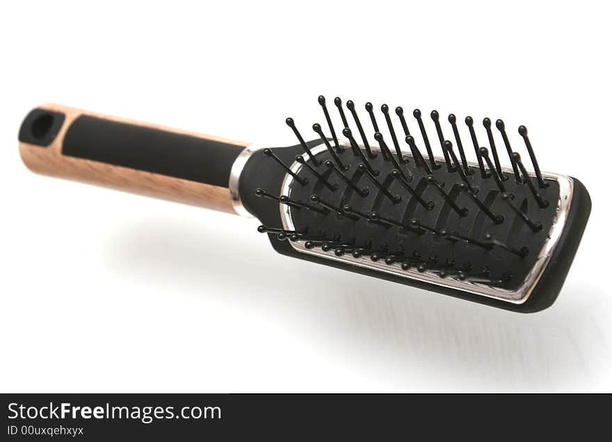 Black hairbrush on a white background