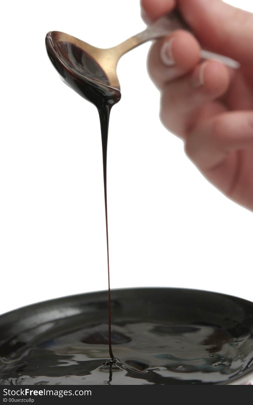 Drops of chocolate on the spoon and a plate