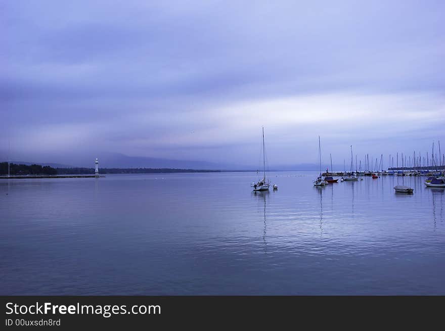 Quiet sailboat lough in the morning, geneva lake, switzerland. Quiet sailboat lough in the morning, geneva lake, switzerland.