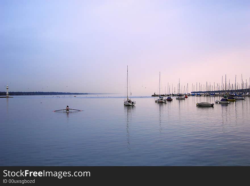 Sailboat lough in the morning, first sun rays, geneva lake, switzerland.