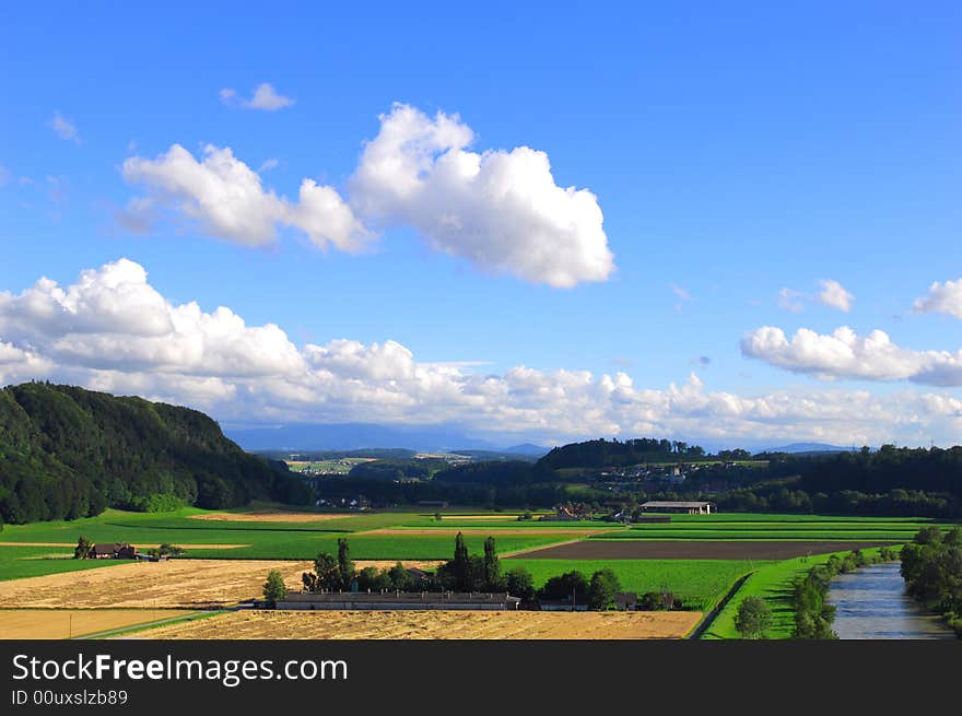 Green hill, colorful field and blue sky. taked in switzerland. Green hill, colorful field and blue sky. taked in switzerland.