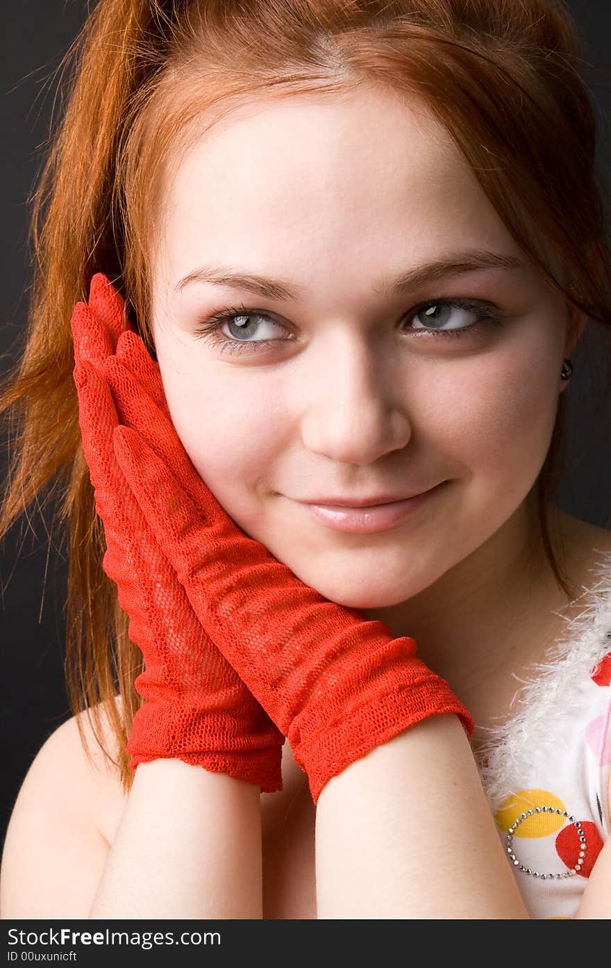 The charming young girl in studio on black background