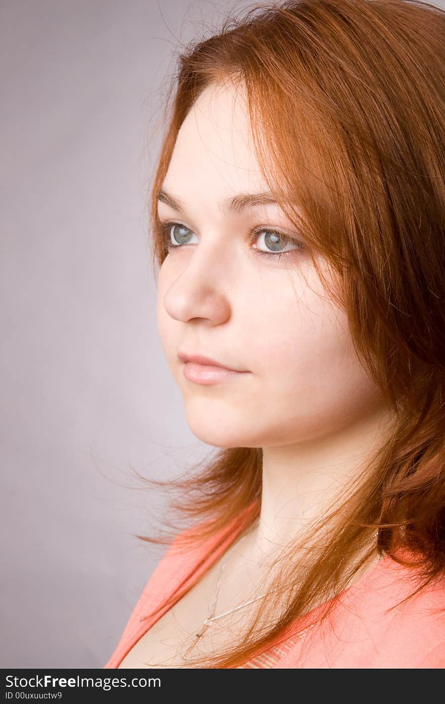 The charming young girl in studio on black background