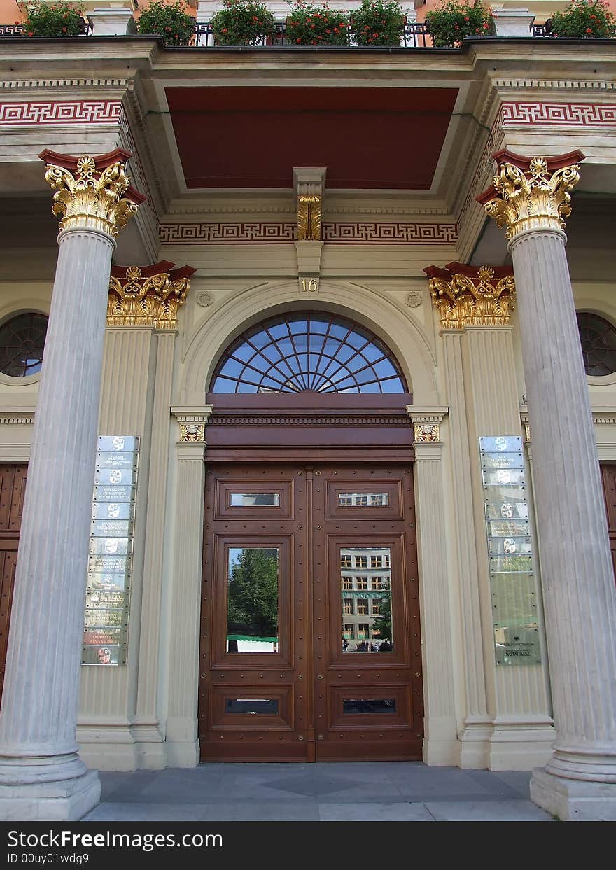 The old wooden door among columns