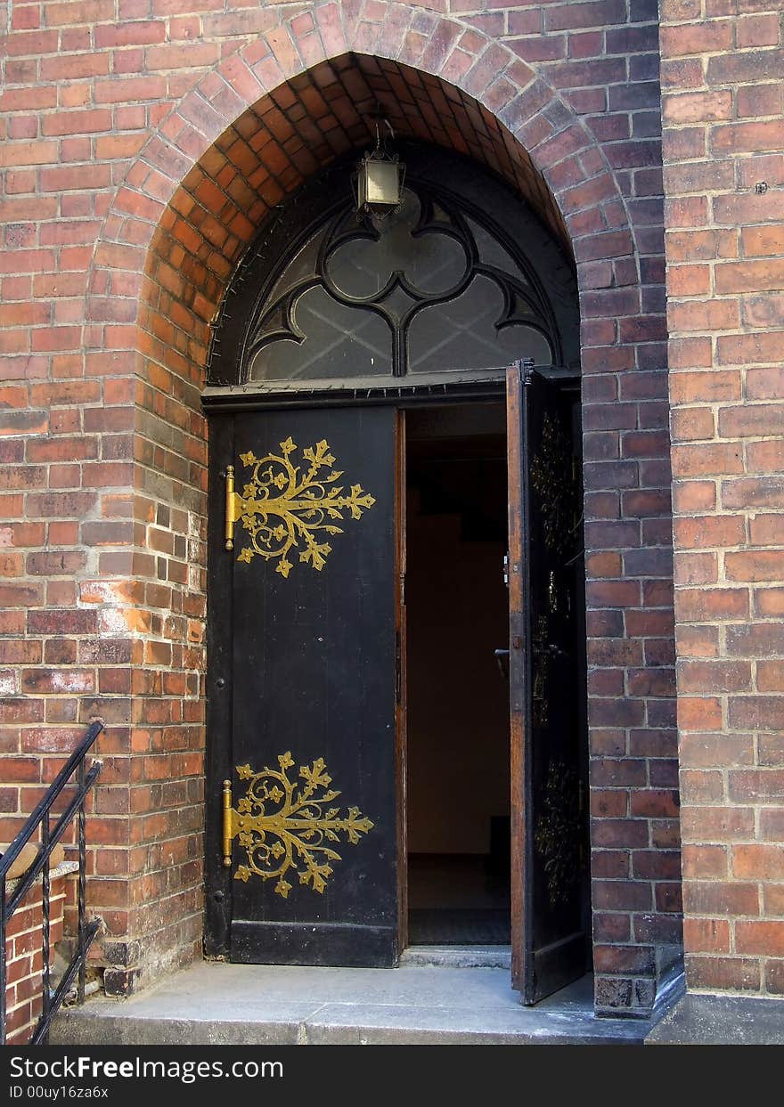 The open arched door with gold embellishments