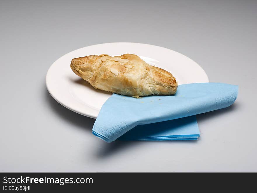 Croissants on a plate with a blue tissue