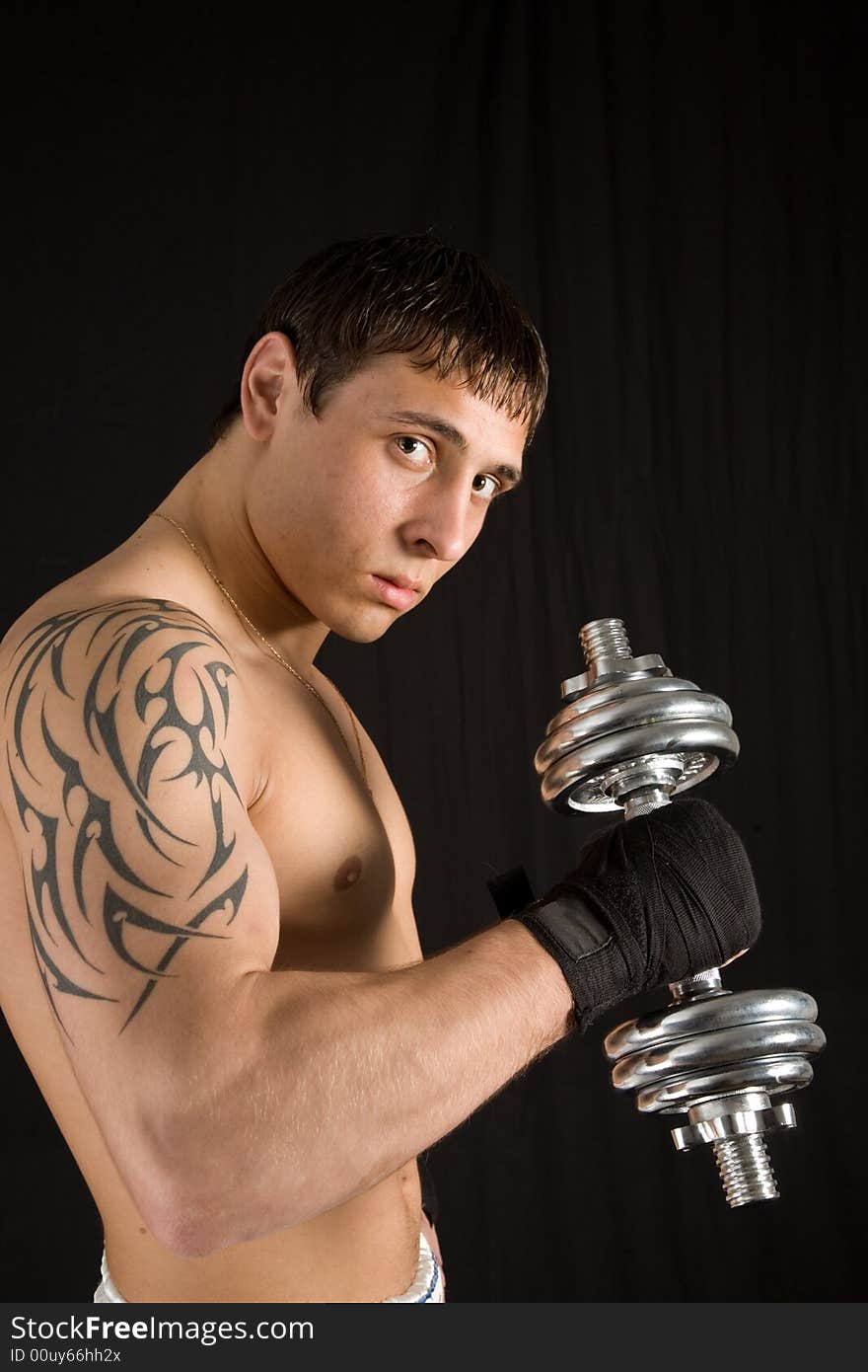 Portrait of a young man with the barbell. Portrait of a young man with the barbell.