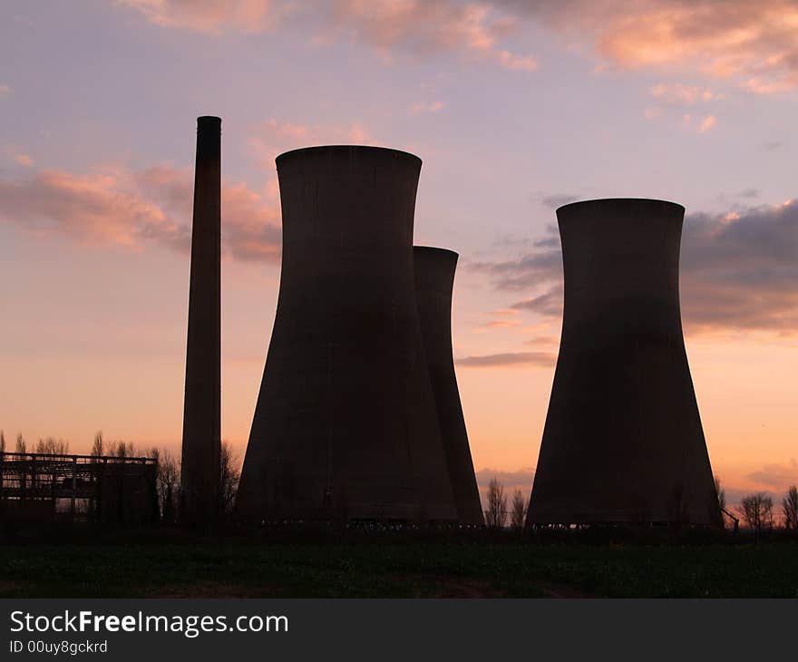 Industrial chimneys in sunset light.