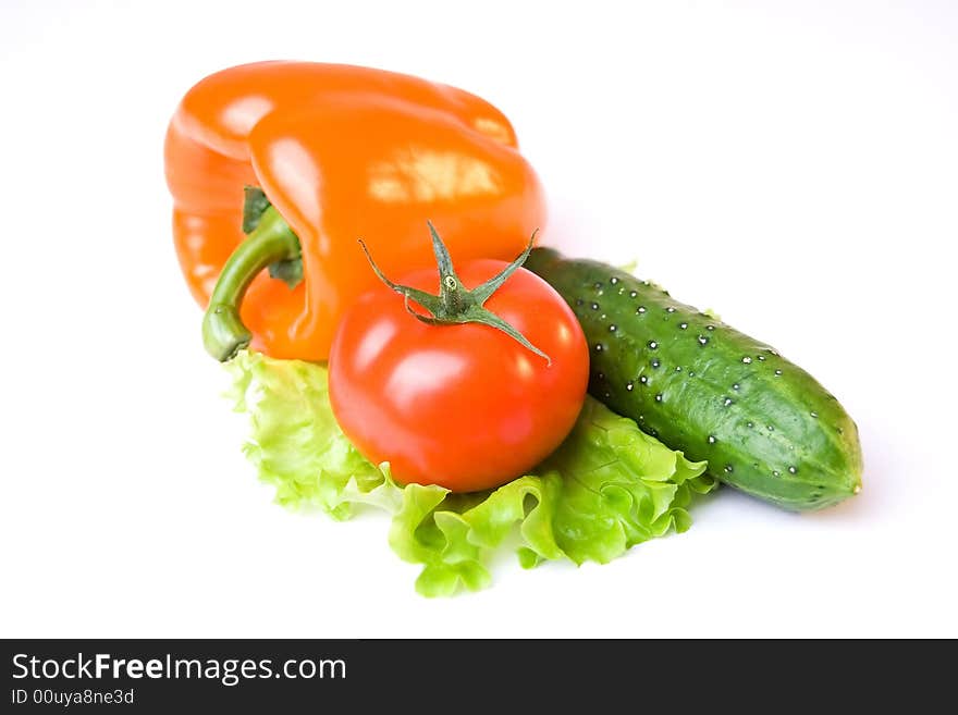 A photo of a cucumber, tomato and paprika. A photo of a cucumber, tomato and paprika