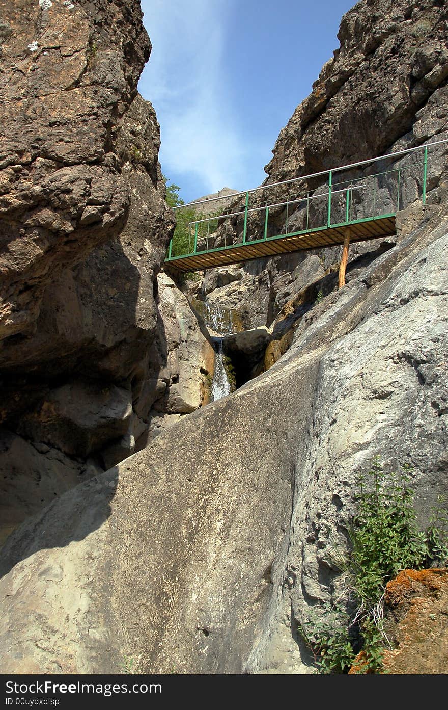 Little bridge through couloir in mountains. Little bridge through couloir in mountains