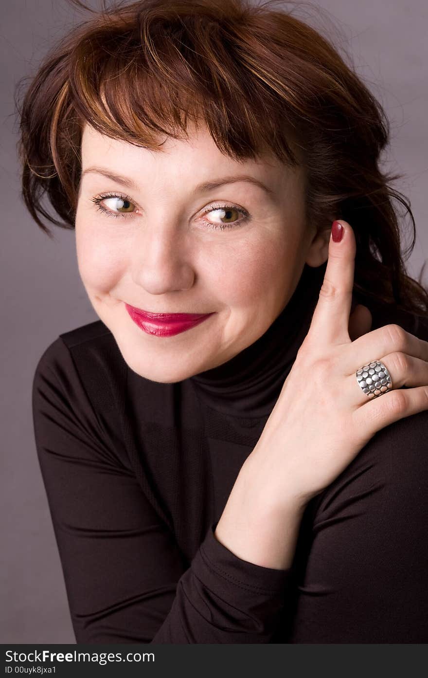 Portrait of the woman in studio on a grey background. Portrait of the woman in studio on a grey background.