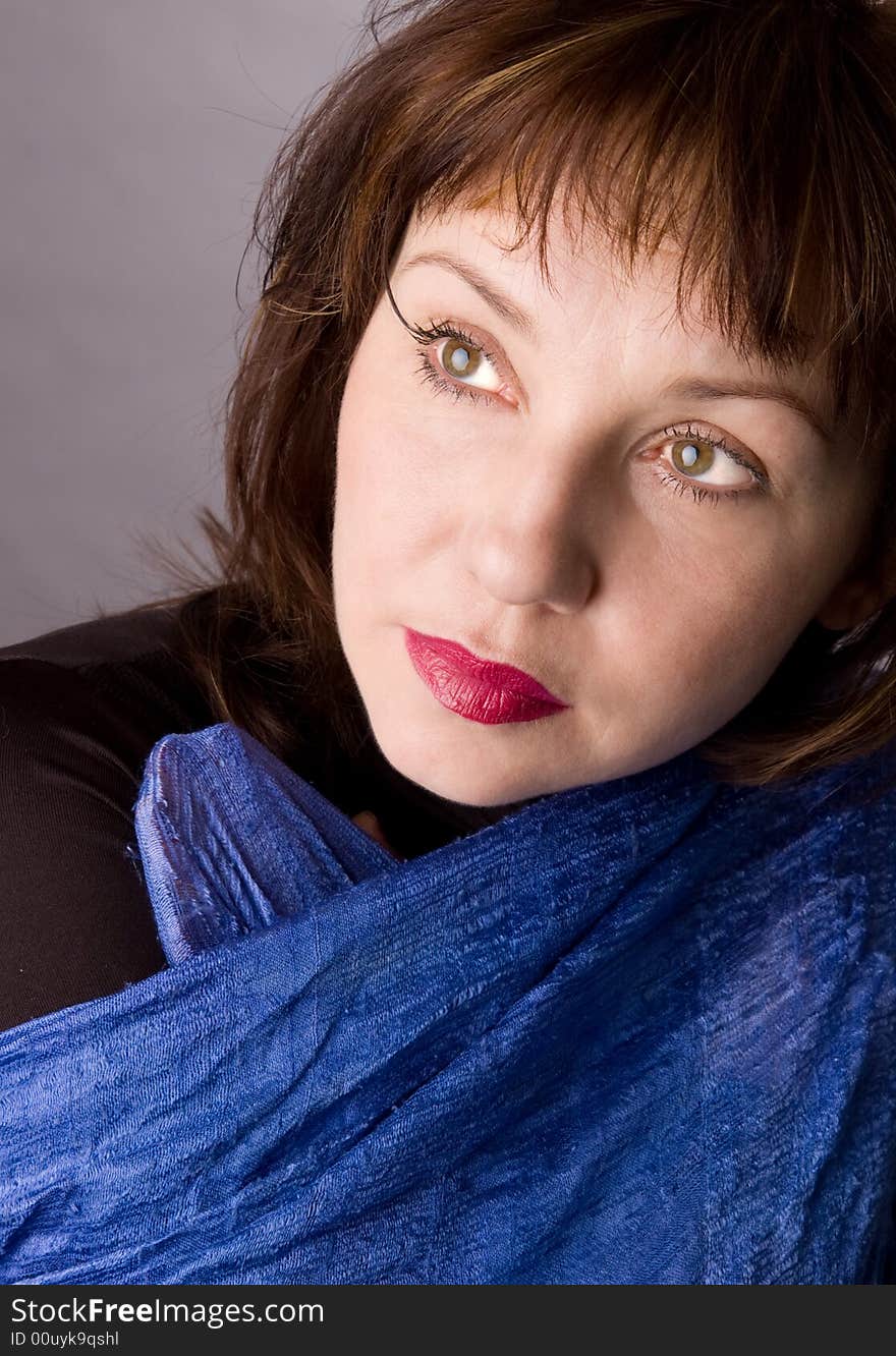 Portrait of the woman in studio on a grey background. Portrait of the woman in studio on a grey background.