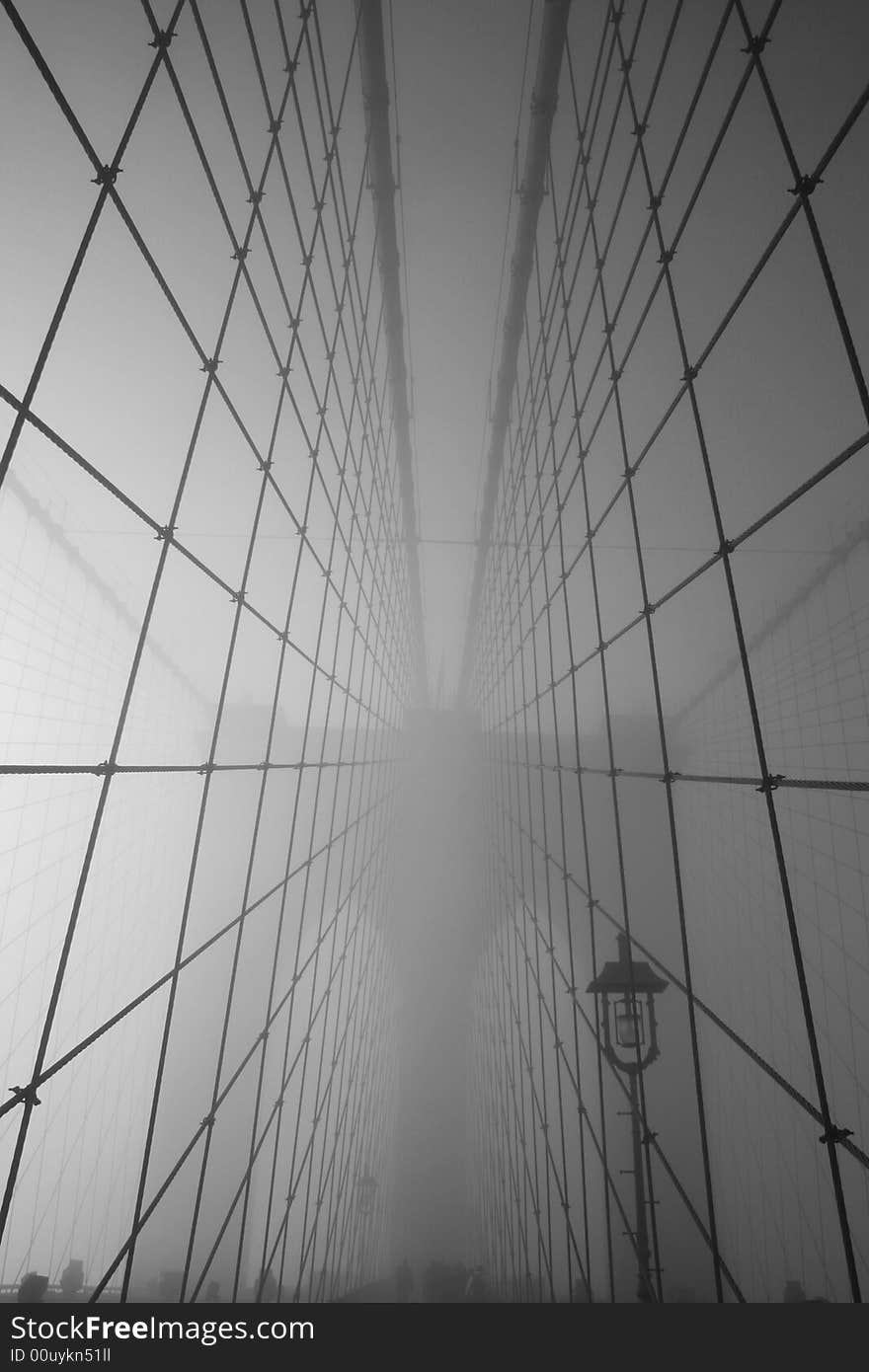 Cables leading to the main tower of the Brooklyn Bridge on a foggy morning.