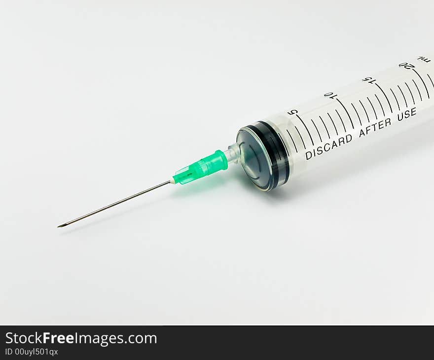 Syringe with hypodermic needle against white background