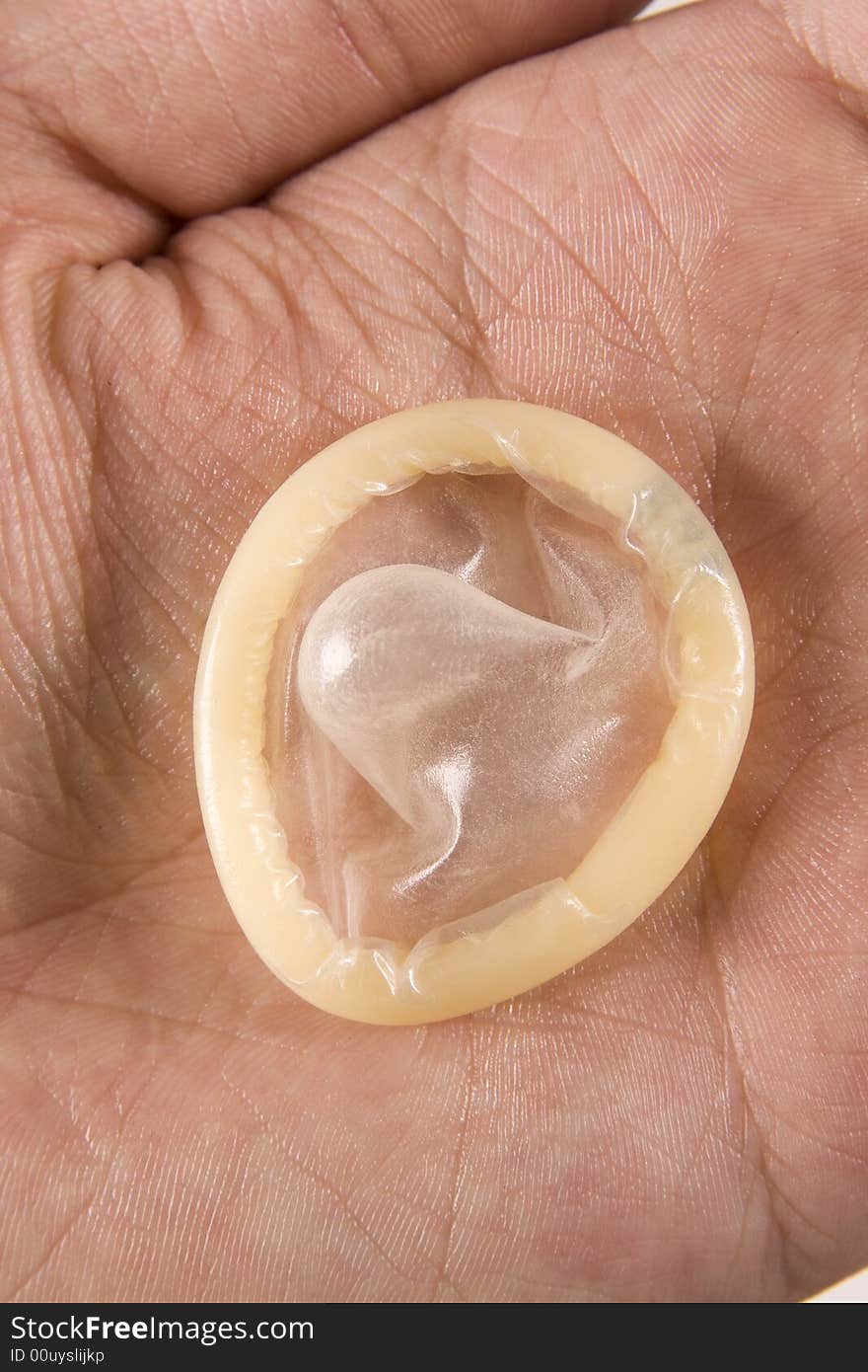 Mans hand holding latex condom. Mans hand holding latex condom