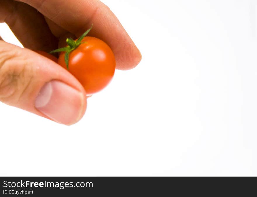 Tomato ingredient being dropped by hand