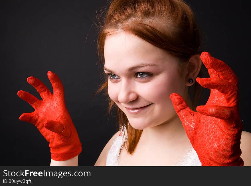 The charming young girl in studio on black background