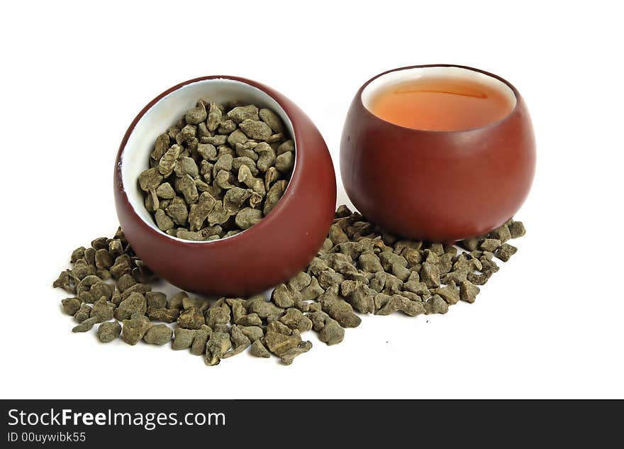 Cup of dried green tea leaves with ginseng and cup of tea. Cup of dried green tea leaves with ginseng and cup of tea