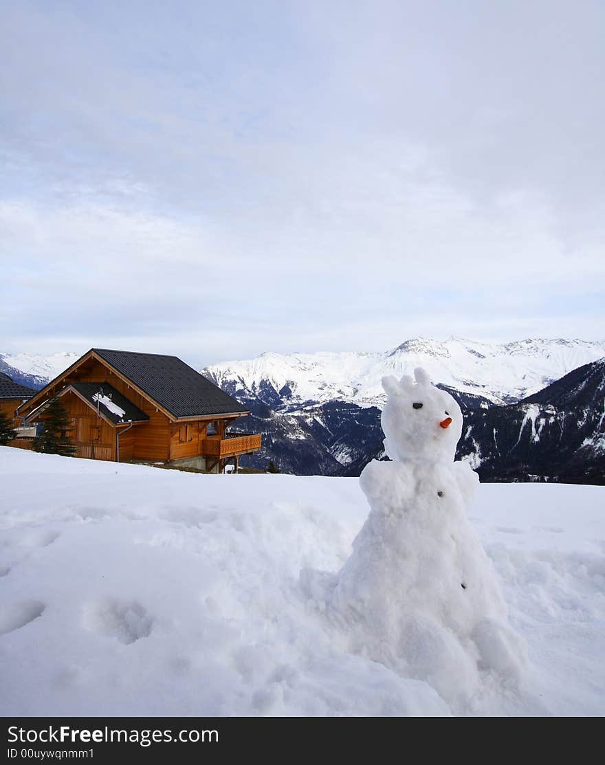 Snowman and chalet