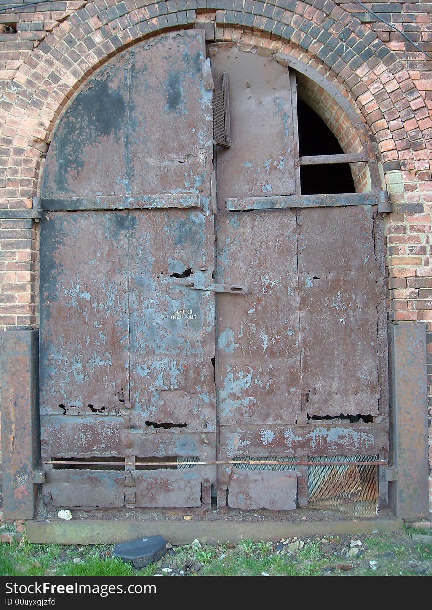 Rusted steel door on an old Brooklyn factory wall. Rusted steel door on an old Brooklyn factory wall.