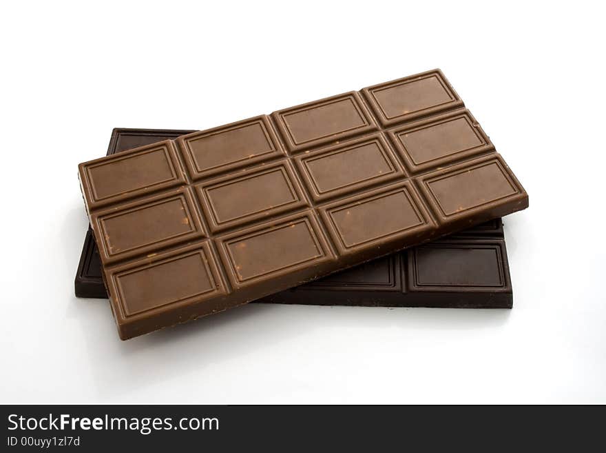 Blocks of black and milky chocolate isolated on white. Blocks of black and milky chocolate isolated on white