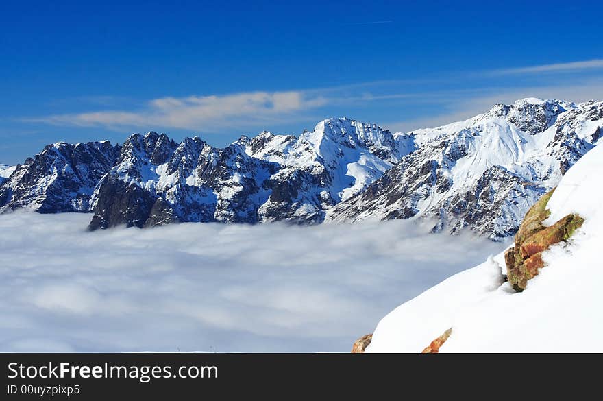 Mountains summits under a blue sky in winter. Mountains summits under a blue sky in winter