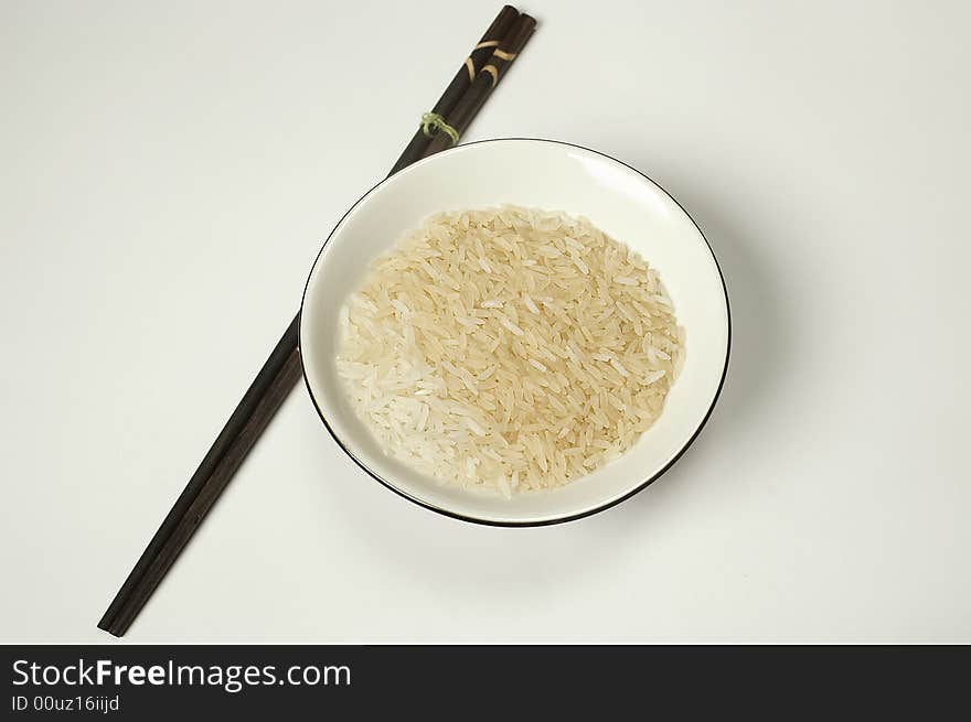 Bowl rice and japanese or chinese dark sticks. Bowl rice and japanese or chinese dark sticks