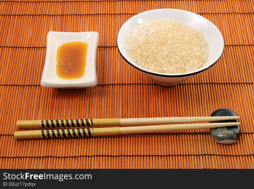 Place with rice bowl, japanese or chinese sticks, sauce and place-mat. Place with rice bowl, japanese or chinese sticks, sauce and place-mat