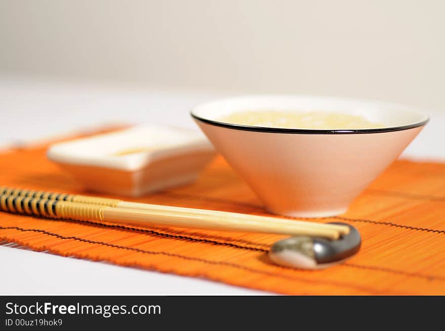 Place with rice bowl, japanese or chinese sticks, sauce and place-mat. Place with rice bowl, japanese or chinese sticks, sauce and place-mat