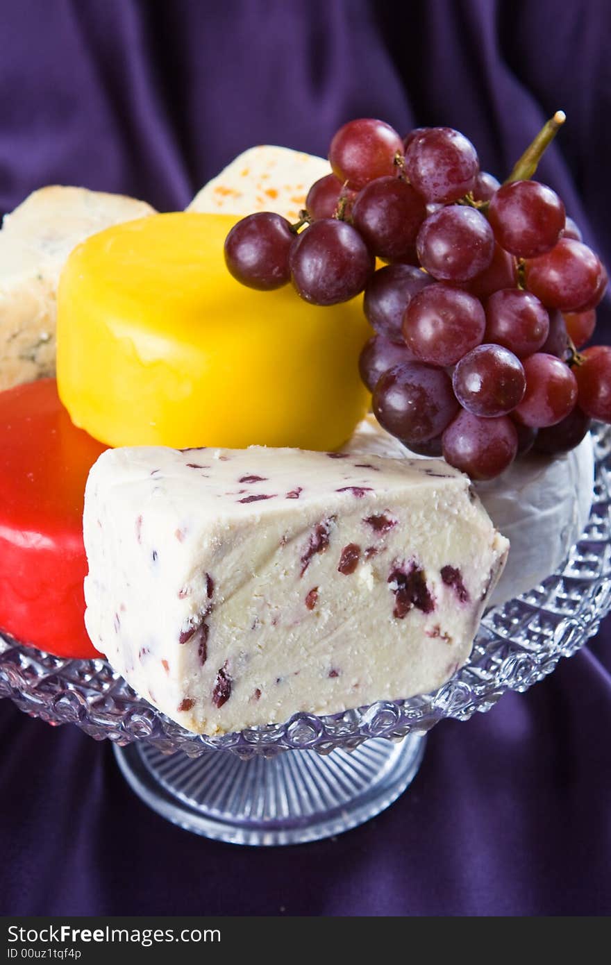 Cheese and grape selection with a purple background