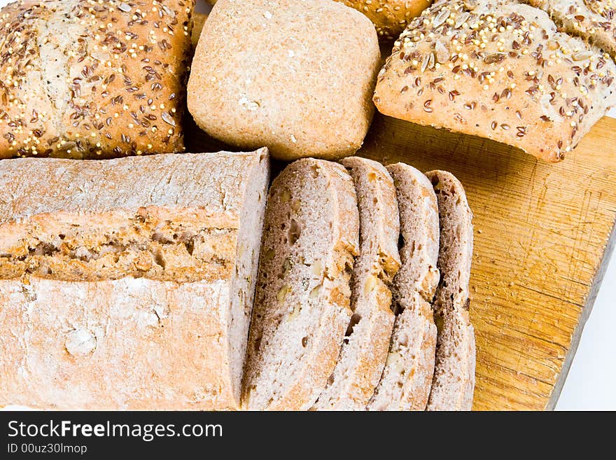 Sliced bread with bread buns on a wooden board