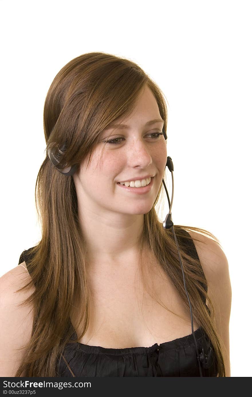 Pretty young lady with cute freckles, wearing a black top and isolated on white, communicating over a headset. Pretty young lady with cute freckles, wearing a black top and isolated on white, communicating over a headset.