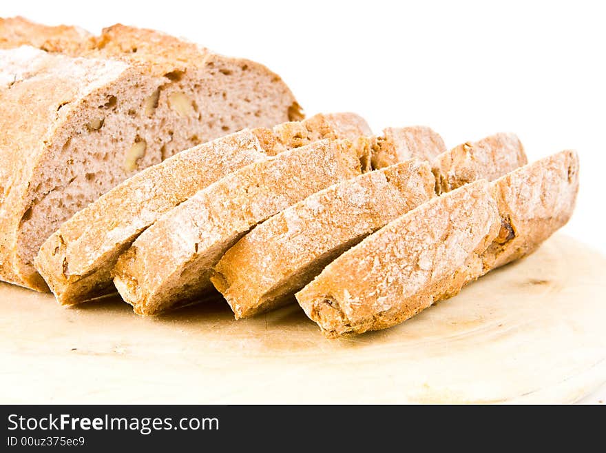 Sliced walnut bread on a wooden board